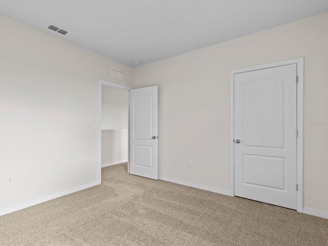 unfurnished bedroom with light colored carpet