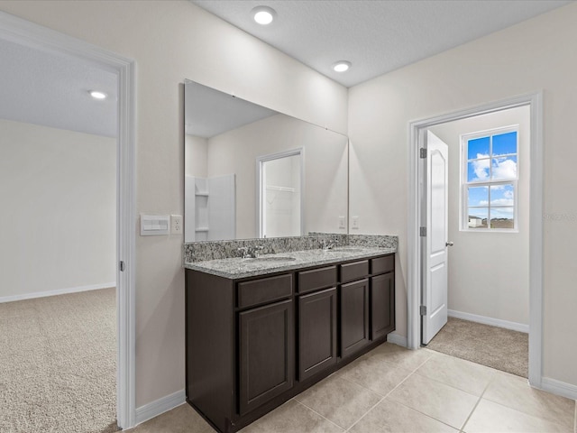 bathroom featuring tile patterned flooring and vanity