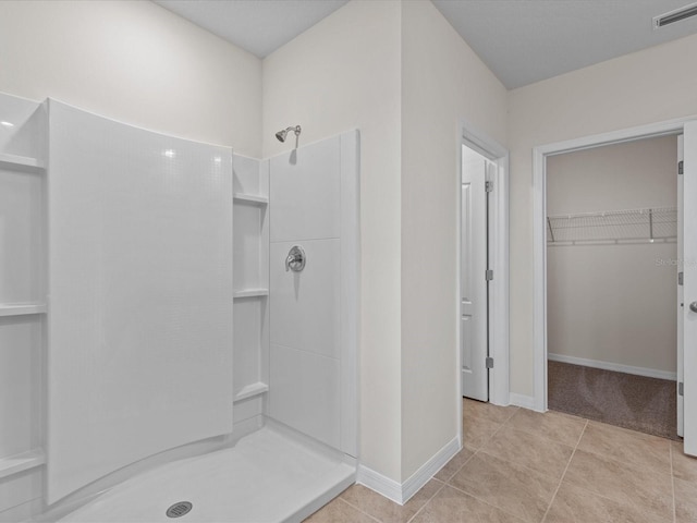 bathroom featuring tile patterned flooring and walk in shower