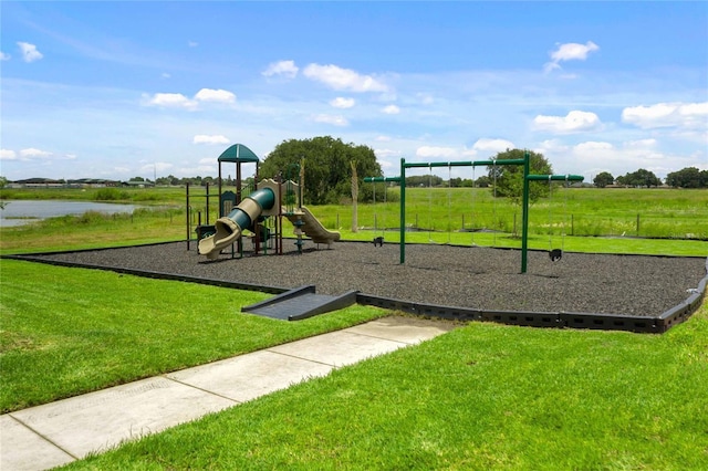 view of playground featuring a yard and a water view