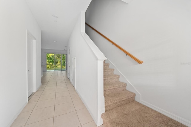 stairs featuring tile patterned floors