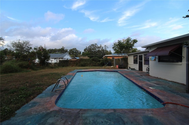 view of pool featuring a yard and a patio