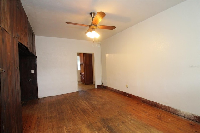 unfurnished bedroom with ceiling fan, hardwood / wood-style flooring, and baseboards