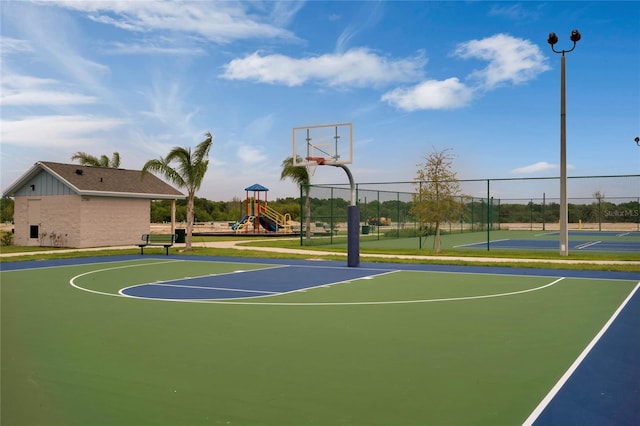 view of basketball court with a playground