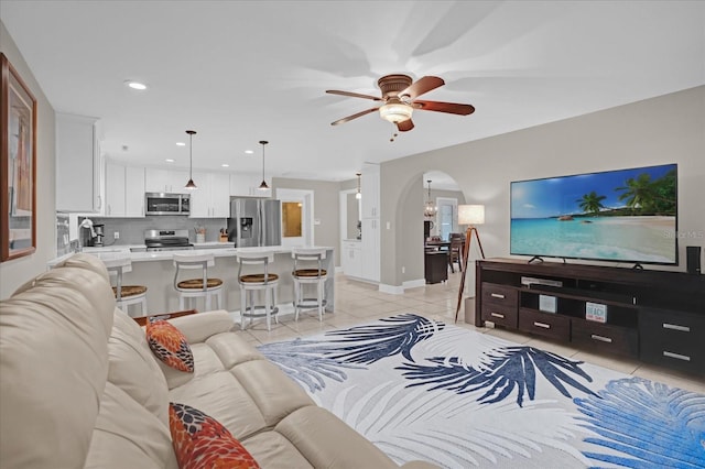 living room featuring light tile patterned floors and ceiling fan