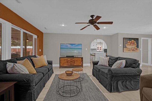 tiled living room with ceiling fan