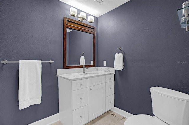 bathroom with vanity, toilet, and tile patterned flooring