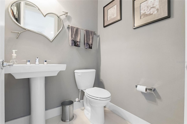 bathroom featuring tile patterned flooring and toilet