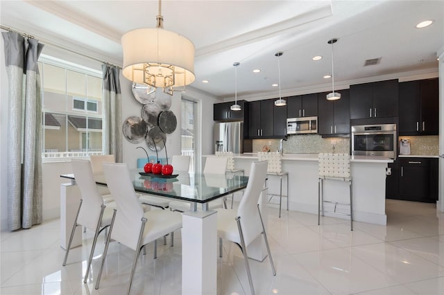 tiled dining room featuring ornamental molding