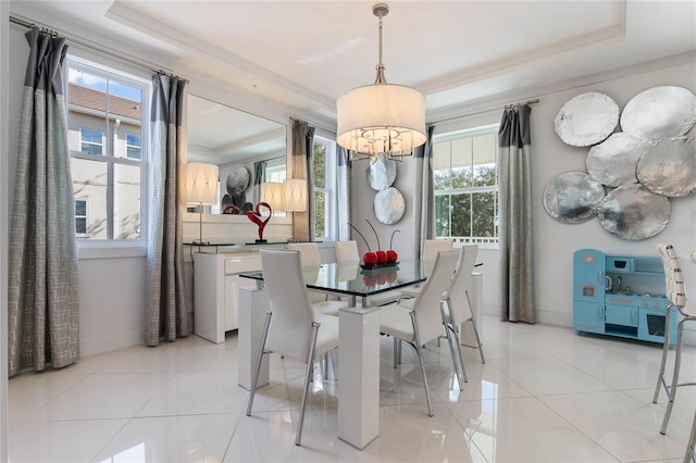 dining area featuring light tile patterned floors, a tray ceiling, and ornamental molding