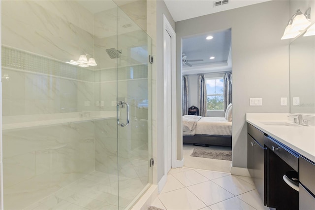 bathroom with ceiling fan, tile patterned floors, a shower with door, and vanity