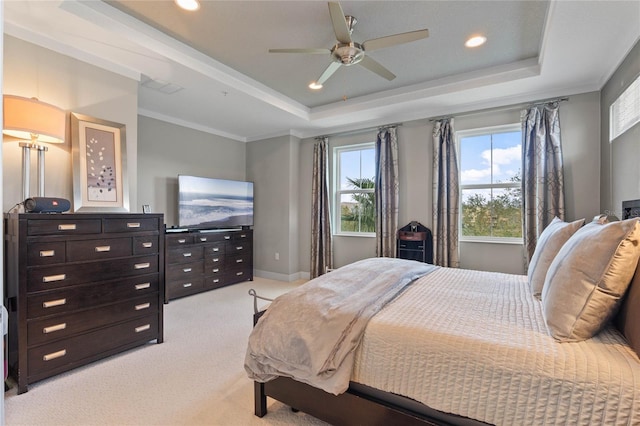 carpeted bedroom featuring crown molding, ceiling fan, and a tray ceiling