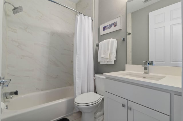 full bathroom with tile patterned floors, vanity, toilet, and shower / bath combo with shower curtain