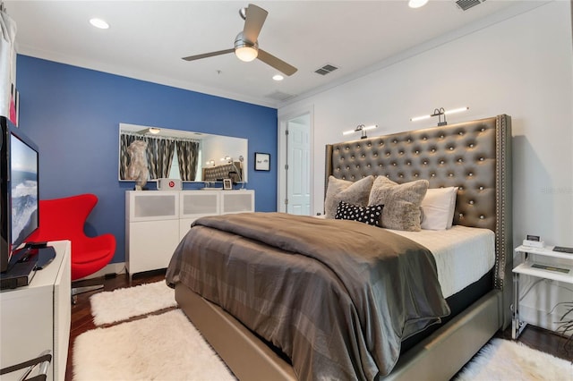 bedroom with wood-type flooring, ornamental molding, and ceiling fan