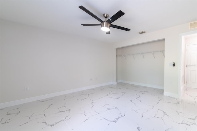 unfurnished bedroom with ceiling fan and a closet