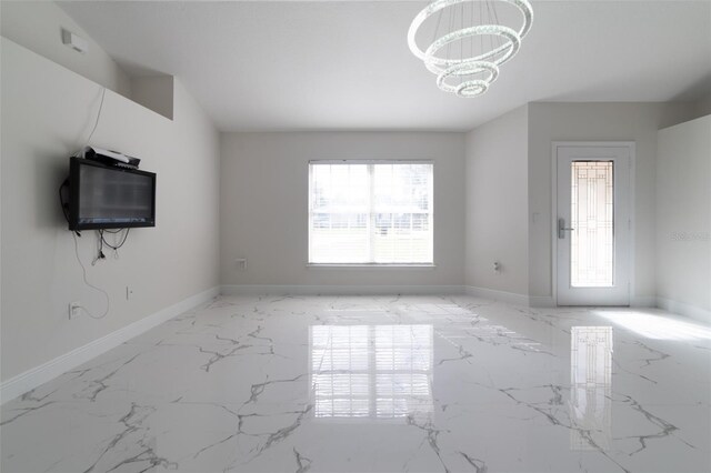 unfurnished living room with a notable chandelier