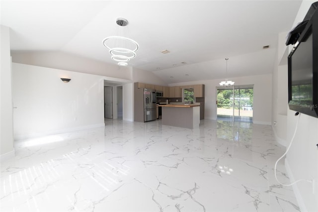 unfurnished living room featuring a chandelier and vaulted ceiling