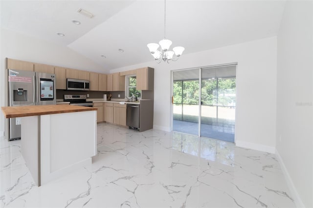 kitchen featuring wood counters, hanging light fixtures, vaulted ceiling, light brown cabinetry, and appliances with stainless steel finishes