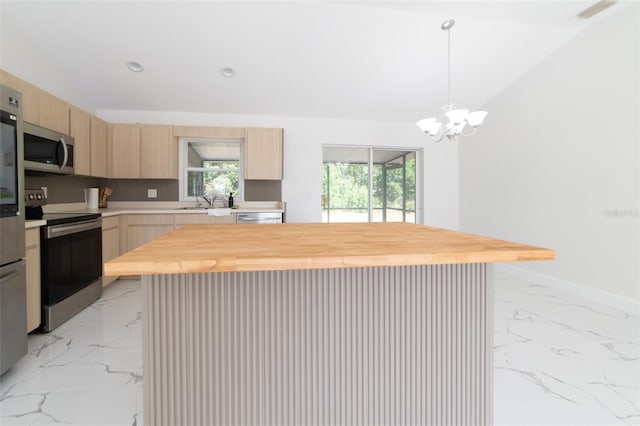 kitchen with a kitchen island, butcher block counters, and stainless steel appliances