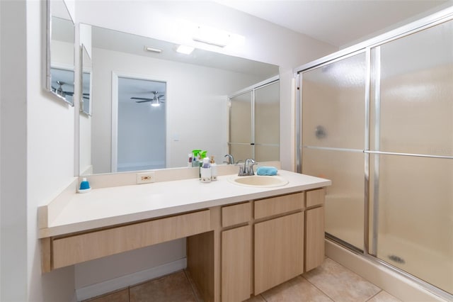 bathroom with ceiling fan, tile patterned flooring, vanity, and a shower with shower door