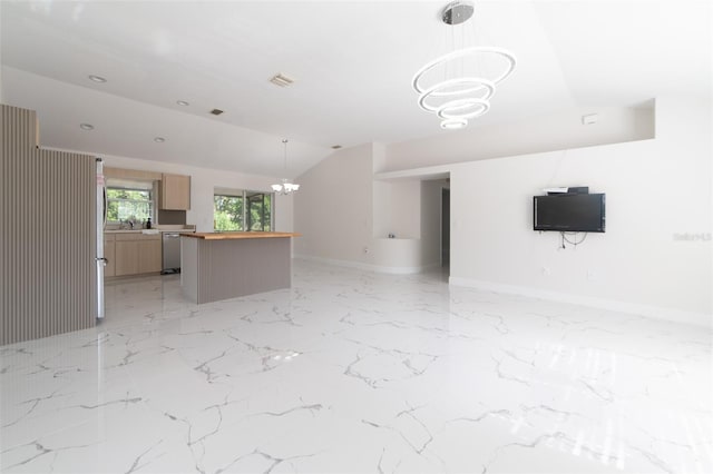 unfurnished living room featuring a notable chandelier and lofted ceiling