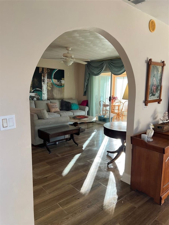 interior space with ceiling fan and dark wood-type flooring