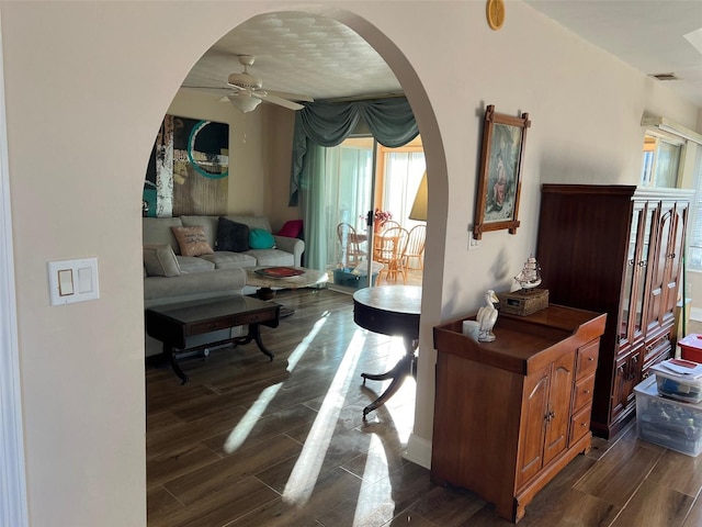 interior space with ceiling fan and dark hardwood / wood-style flooring