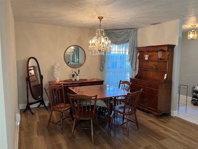 dining space featuring a chandelier and hardwood / wood-style floors