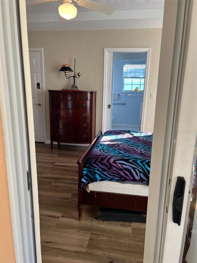 bedroom with ceiling fan and dark hardwood / wood-style flooring