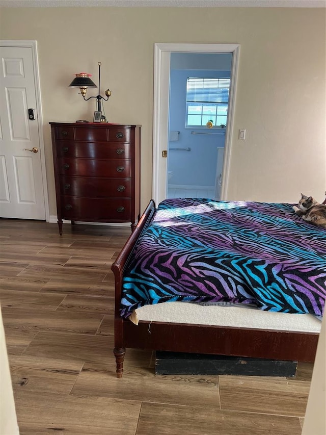 bedroom with dark hardwood / wood-style floors