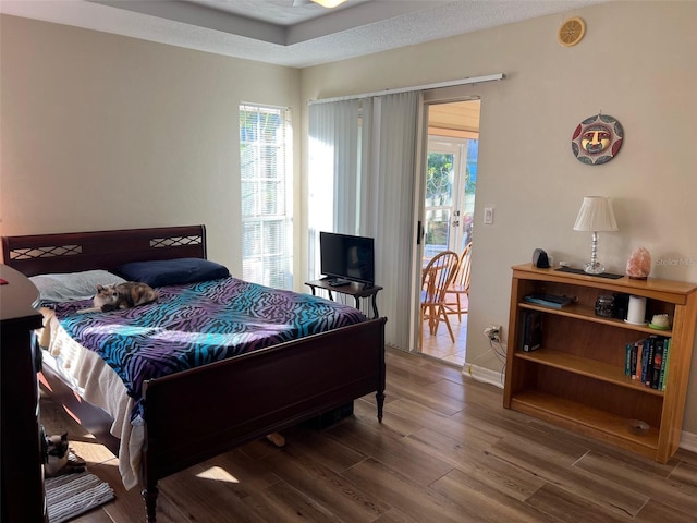 bedroom featuring access to outside and wood-type flooring