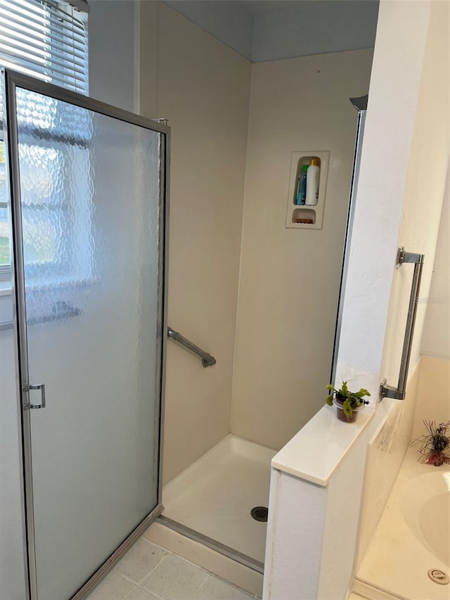 bathroom with tile patterned floors and independent shower and bath