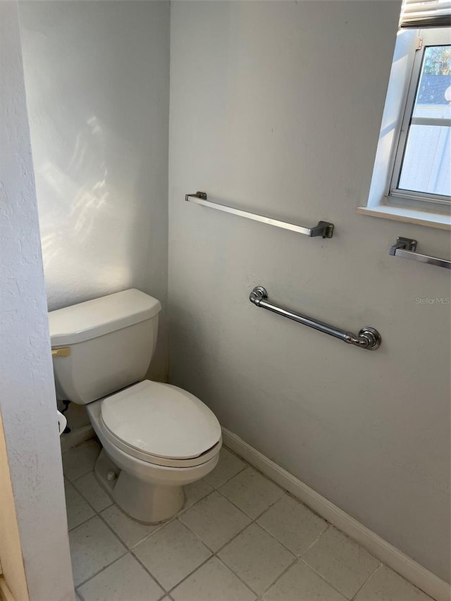 bathroom featuring toilet and tile patterned floors