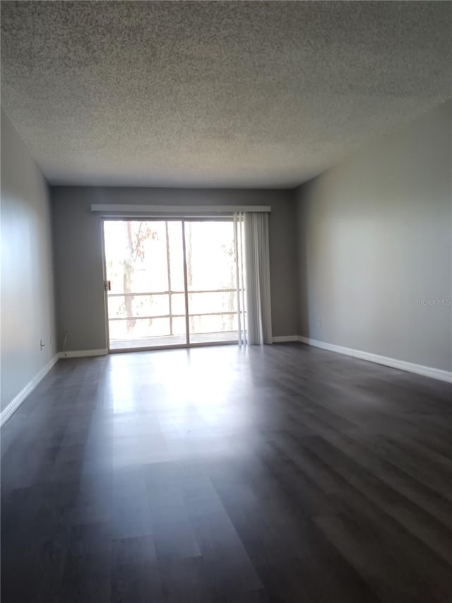 unfurnished room with a textured ceiling