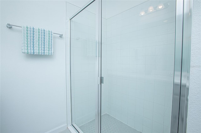 bathroom featuring a shower with door