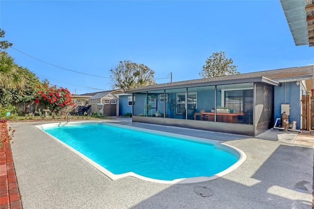 view of swimming pool with a patio area and a sunroom