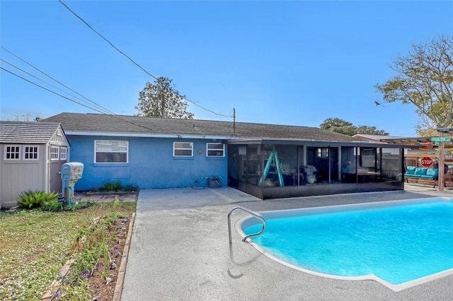 rear view of property featuring a patio and a sunroom