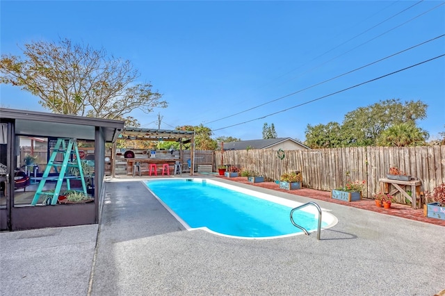 view of swimming pool with a patio area and exterior bar