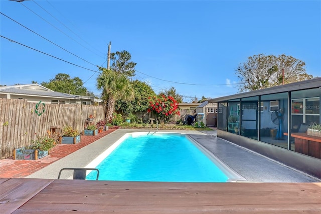 view of swimming pool with a deck