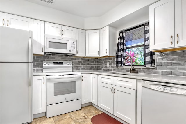 kitchen featuring white appliances, sink, decorative backsplash, and white cabinetry