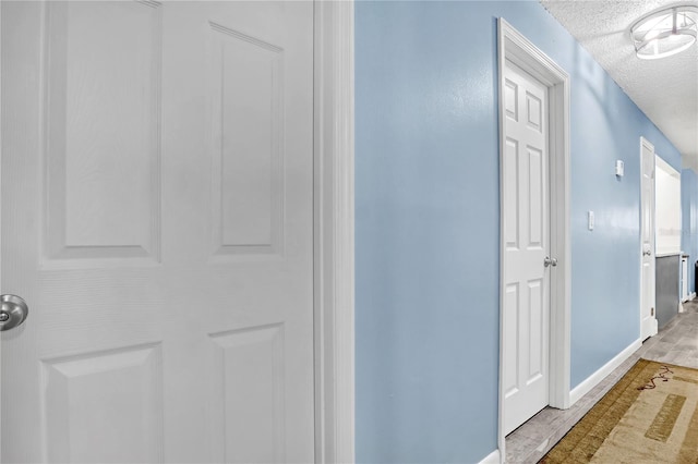 hallway featuring a textured ceiling