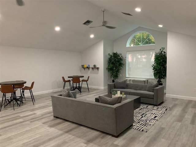 living room featuring ceiling fan, light hardwood / wood-style floors, and lofted ceiling