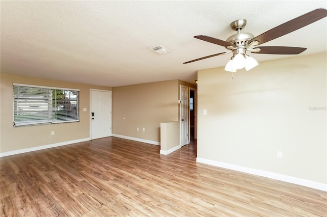 interior space featuring a textured ceiling, light hardwood / wood-style flooring, and ceiling fan