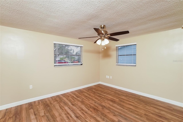 spare room with a textured ceiling, hardwood / wood-style flooring, and ceiling fan