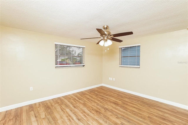 empty room featuring ceiling fan, a textured ceiling, and light hardwood / wood-style flooring