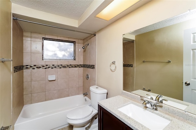 full bathroom with toilet, vanity, a textured ceiling, and tiled shower / bath