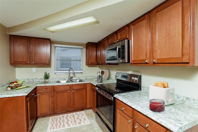 kitchen with light stone countertops, sink, black electric range oven, and light tile patterned floors