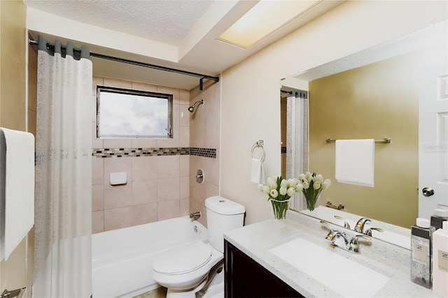 full bathroom featuring a textured ceiling, vanity, toilet, and tiled shower / bath