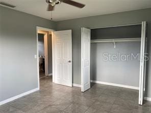 unfurnished bedroom featuring a closet, ceiling fan, and baseboards