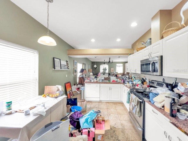 kitchen featuring white cabinets, decorative light fixtures, plenty of natural light, and stainless steel appliances